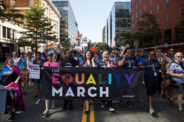 Demonstrators at the front of the crowd lead thousands of others down 17th St. NW during the Equality March in Washington, D.C., on Sunday, June 11.